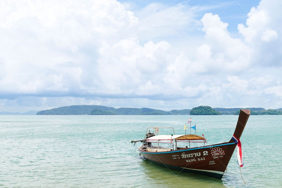 Krabi, Thailand - September 10, 2017 : A photo of Long boat is parking at Ao Nang, Krabi. The long boat belongs Wang Sai seafood Restaurant is written in Thai on it. Wang Sai Seafood, Aonang, Krabi.