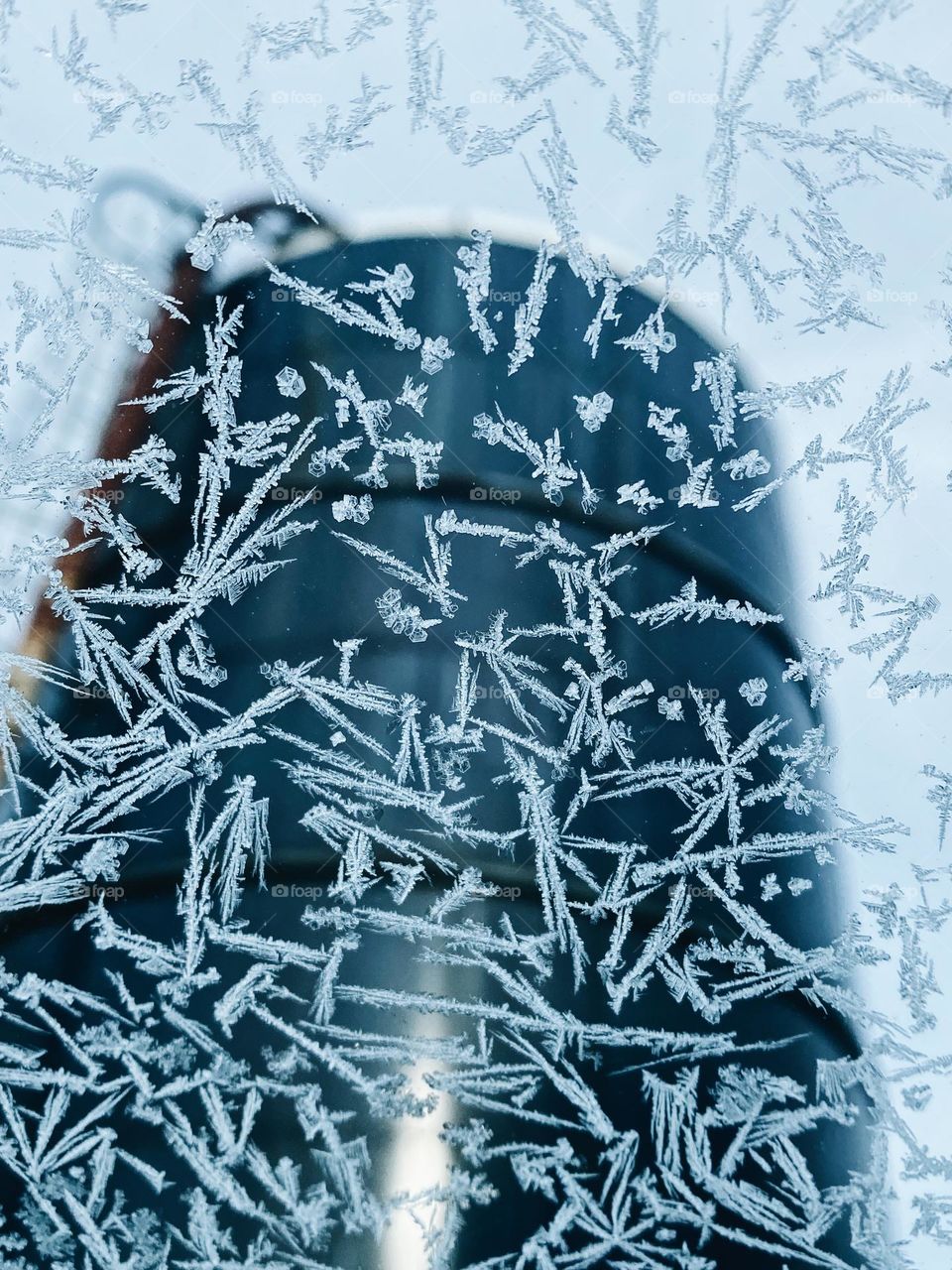 Ice on window with a silo in the background 