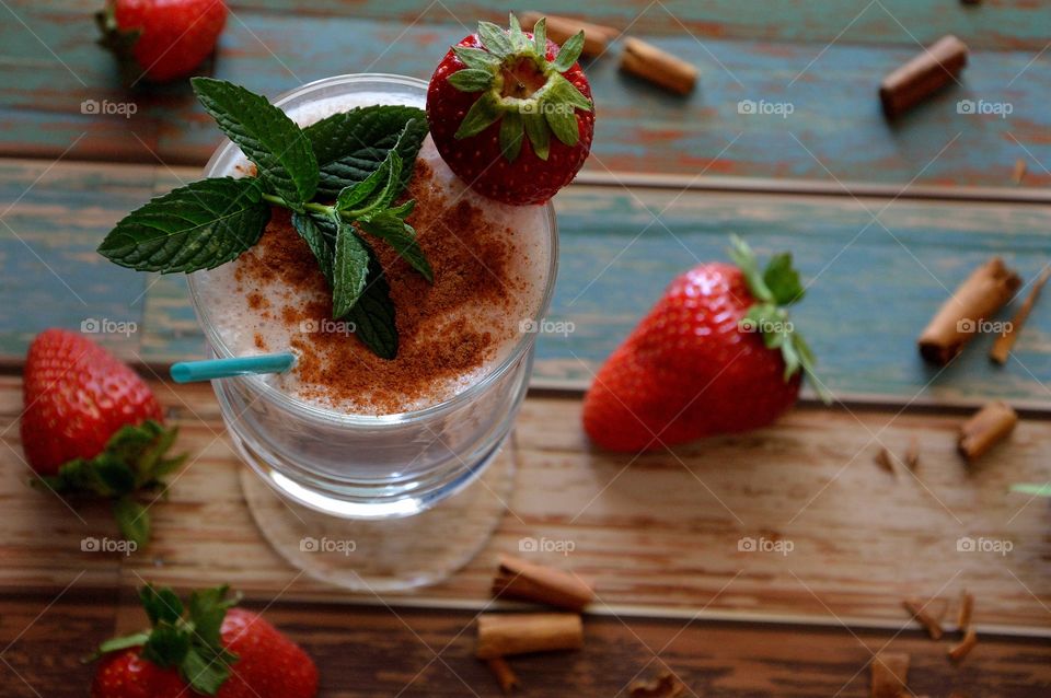 Fresh fruit smoothie garnished with strawberry