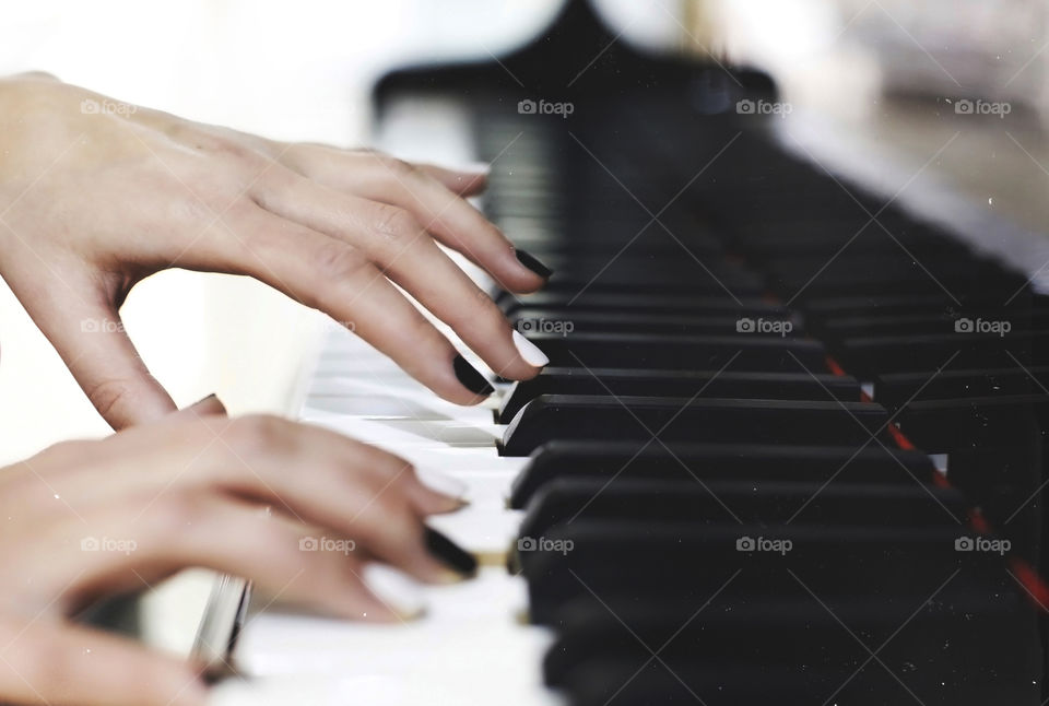 Loving to play piano, musician female hands on keys  