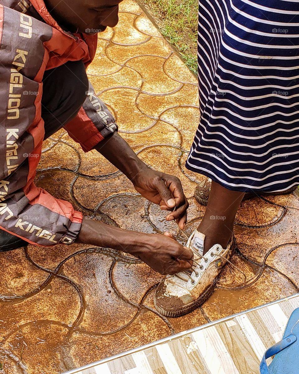 Tying her shoe. Let love lead.