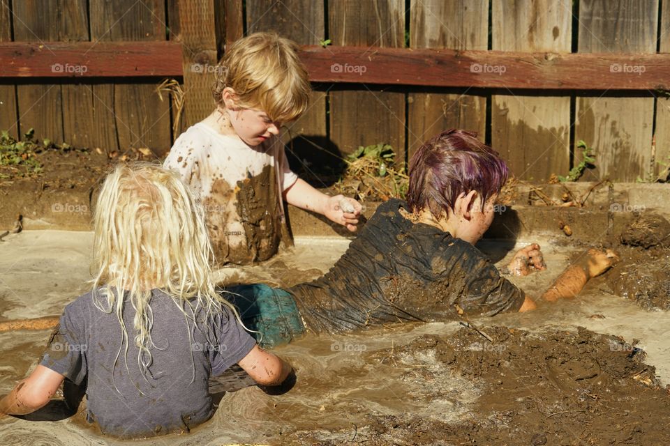 Brothers Playing In Mud