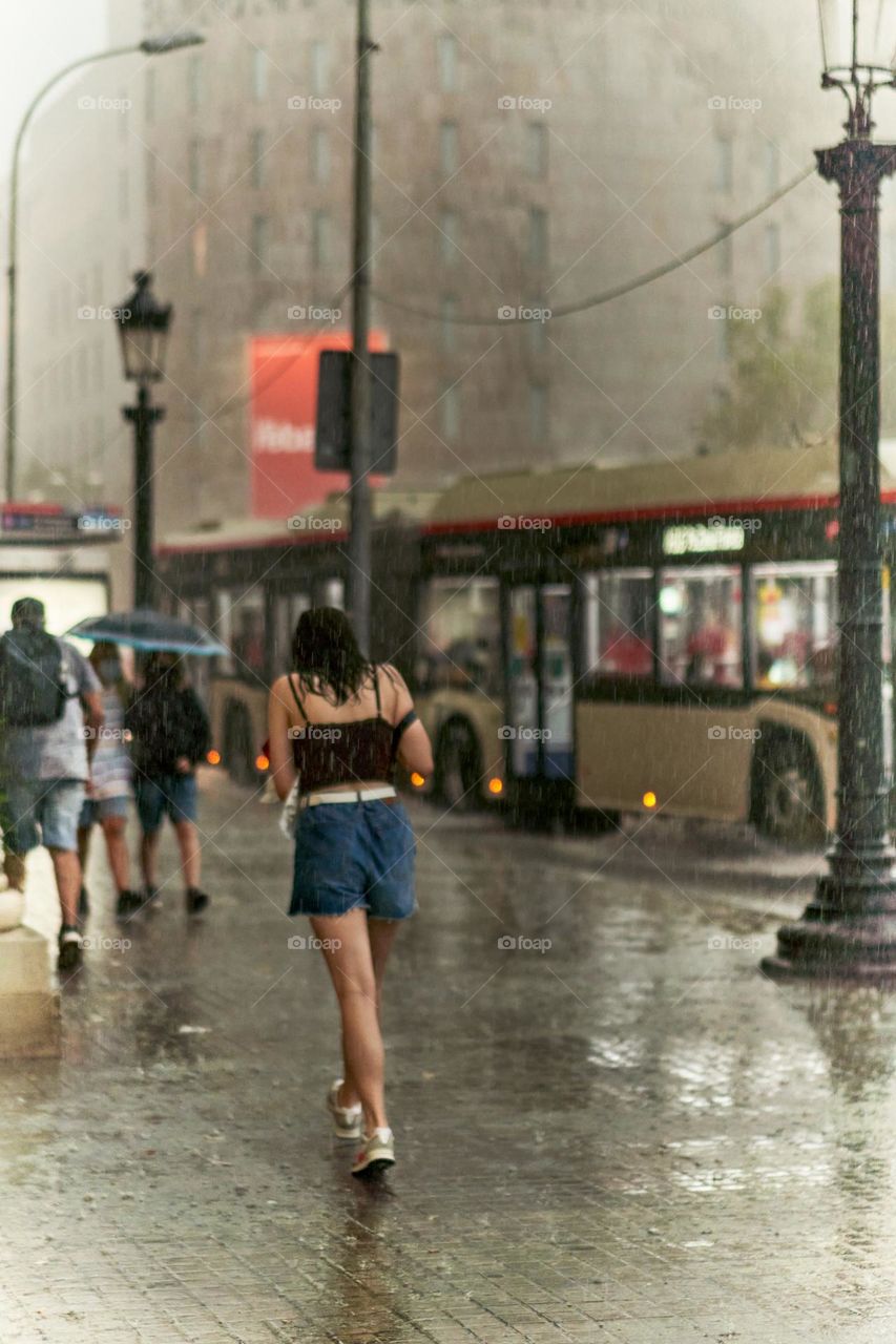 Bus in middle of a Storm while a joung woman is drop