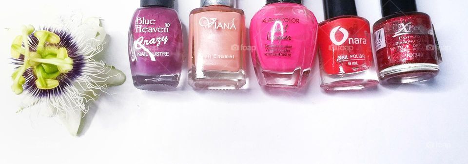 Different brands of nail enamel in different colours - beauty products