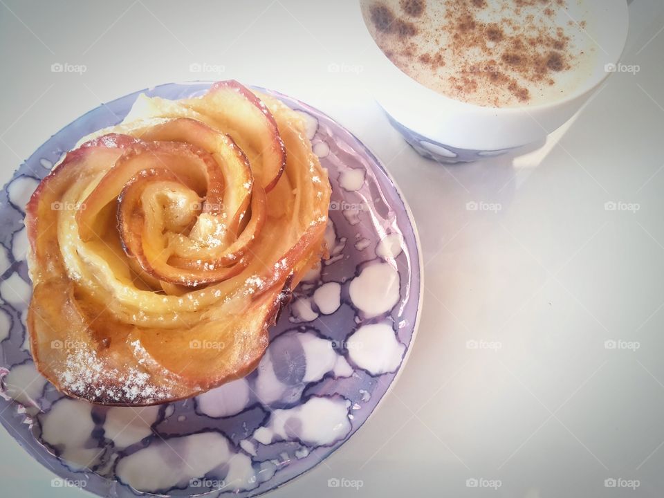 baked apple rose dessert with cappuccino coffee