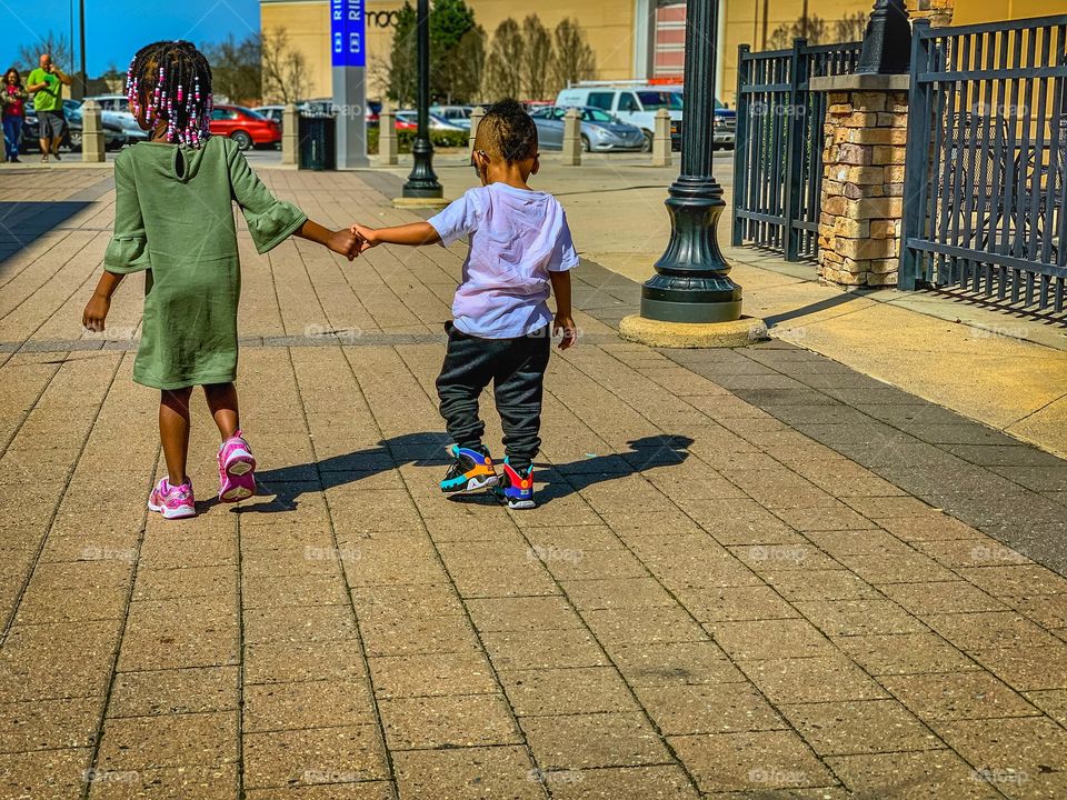 2 kids walking together 