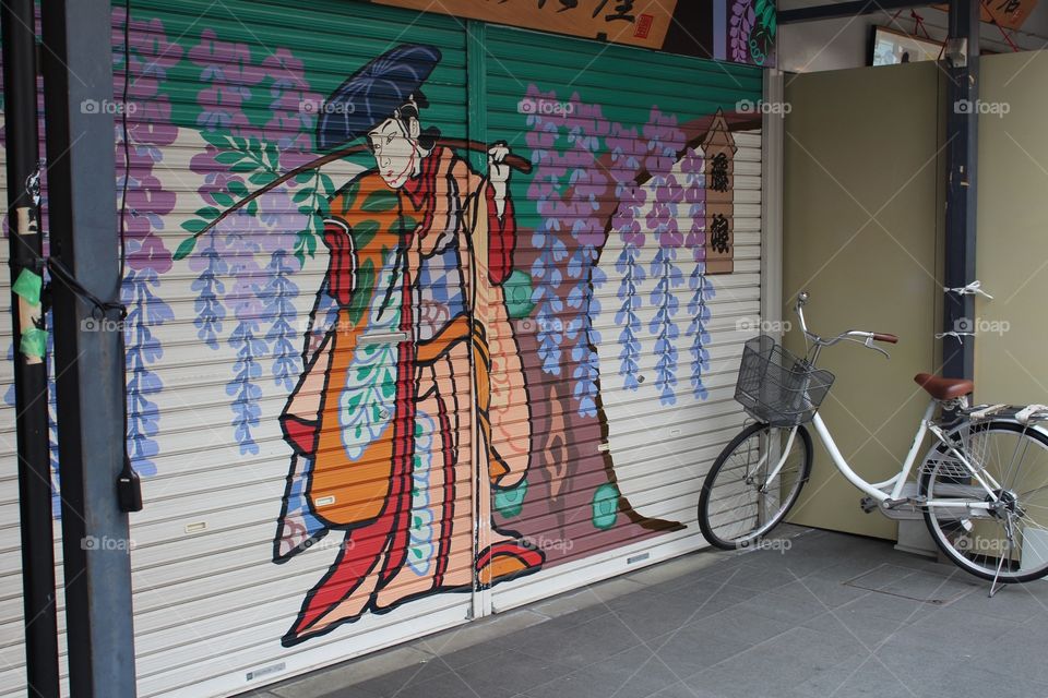 This is a beautifully painted closed market stall in a street market in Tokyo. 