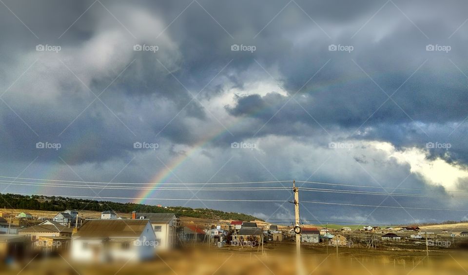 rainbow after the rain on the background of gray clouds!