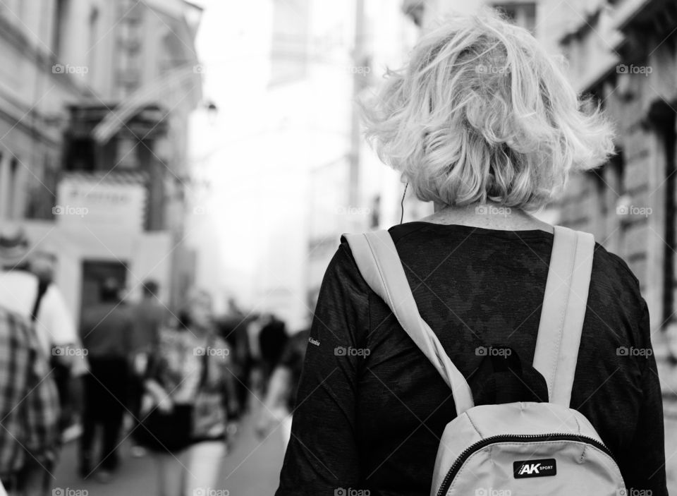 Woman walking on crowded street 
