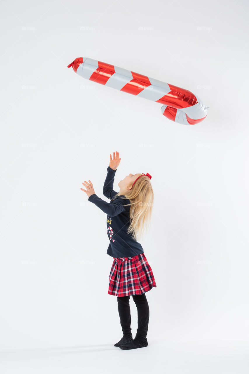 Young girl playing with balloon