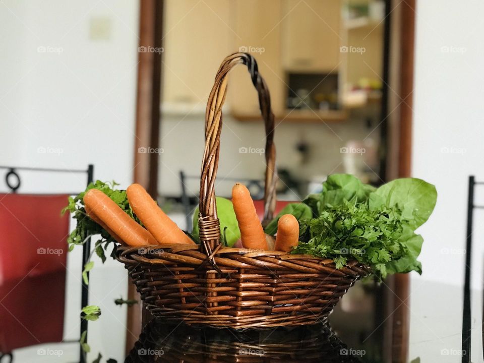 Using Eco friendly reusable bamboo basket with full of vegetables instead of plastic on the dining table 