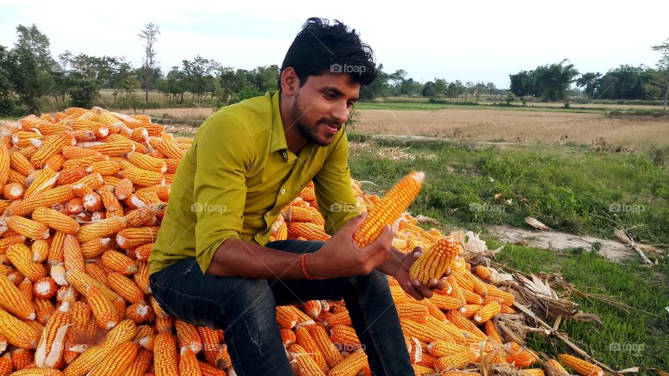 happy farmer with maize