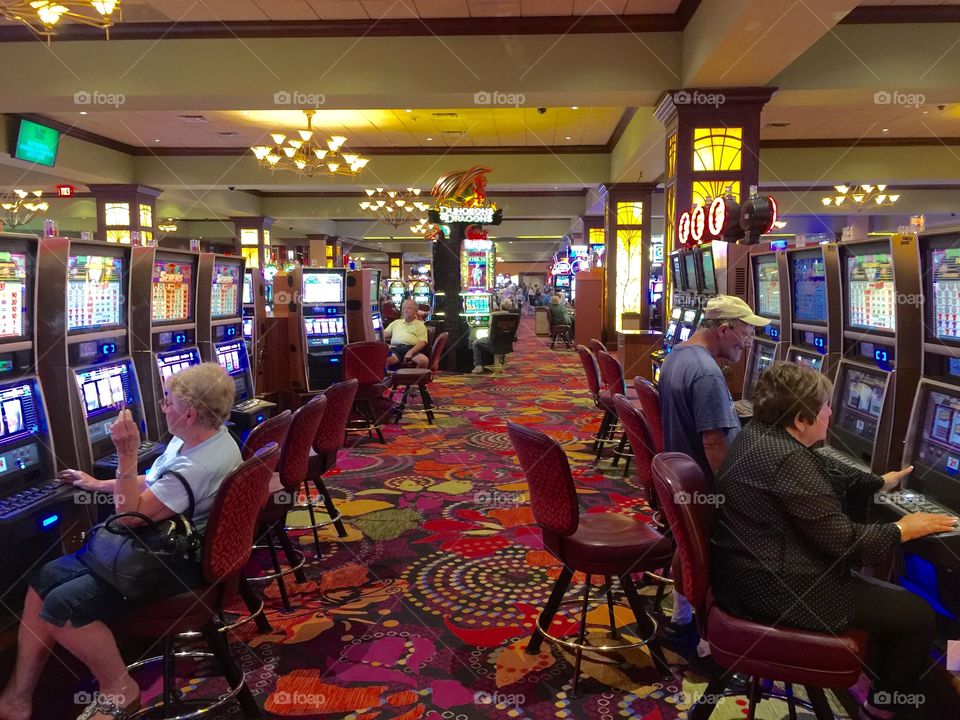 Senior people playing in casino jackpot