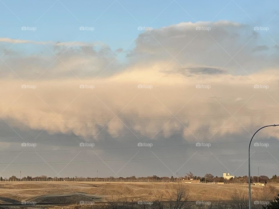 Dark Clouds filled with rain coming over the prairies 