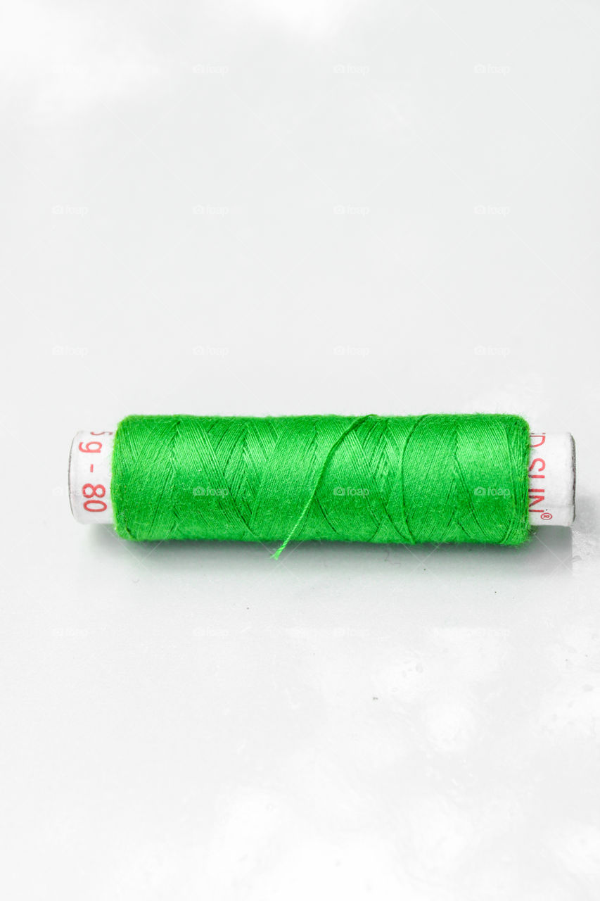 images of green and white colour combination #green colour stitching thread in a white colour background