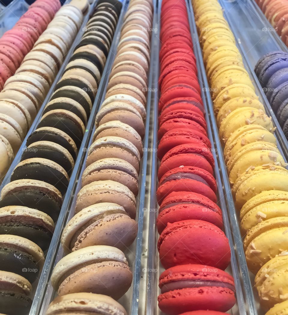 Many colourful macaroons lined up all in a row