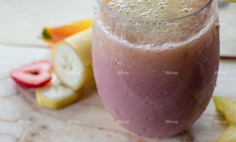 Close-up of Fresh Pink and white smoothie shake fresh summer healthy drink on table with fruit 