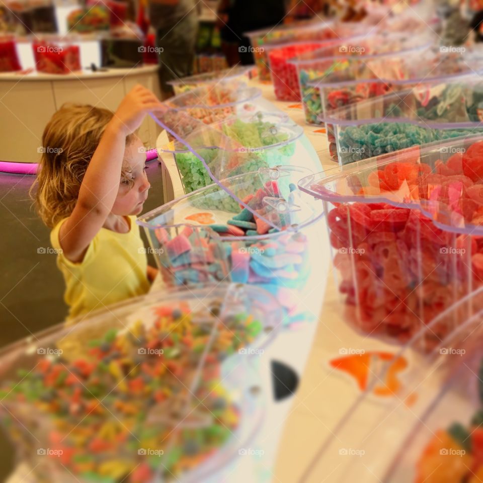 Sweet little girl in a candy store