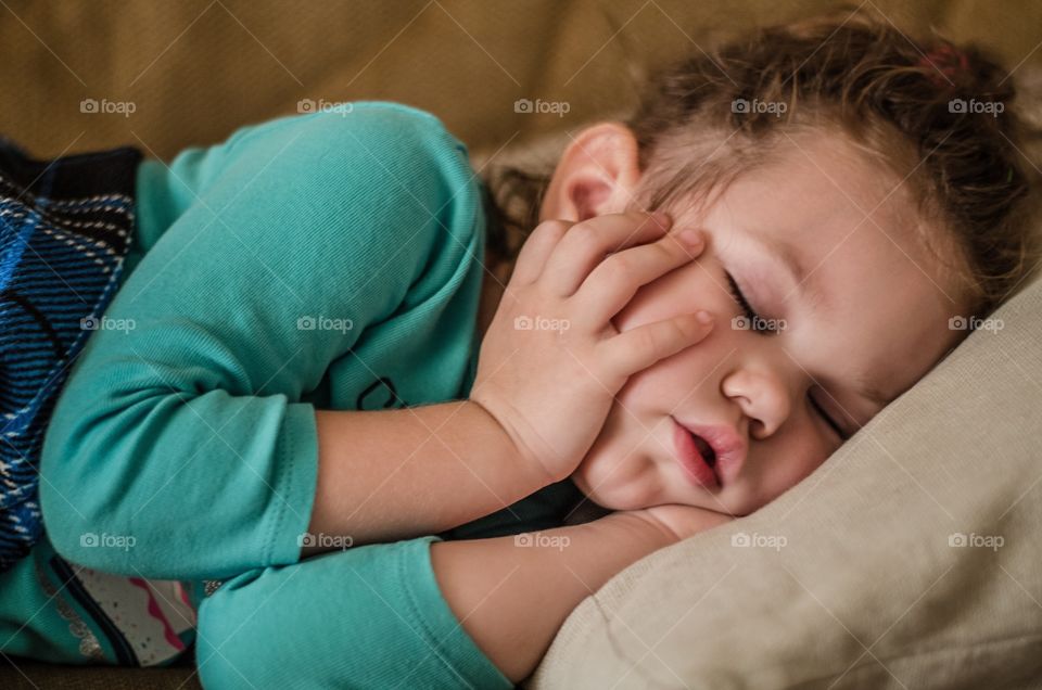 Little girl sleeping on bed