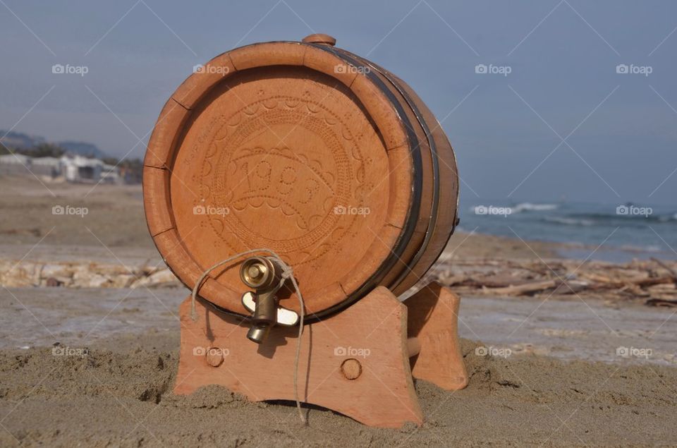 Little wooden barrel on the beach