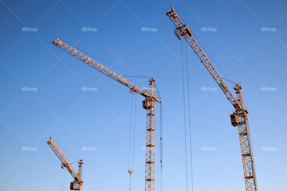 construction cranes on blue sky background