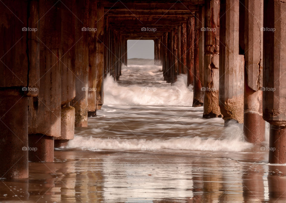Beach wood pier, seascape long exposure time, sea and sand, brown columns fresh water nature landscape environment