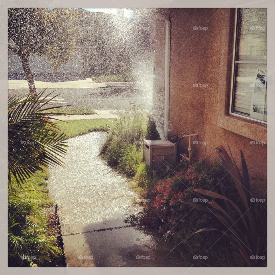 It is raining in the front yard