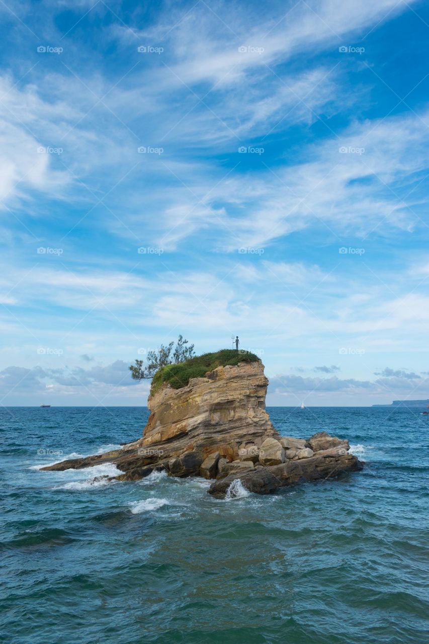 Islet at the beach of El Sardinero in Santander (Spain), with the statue of Neptune as a child.