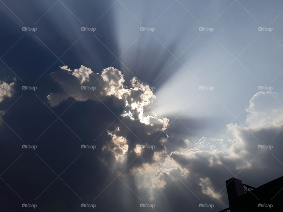sun coming out of clouds