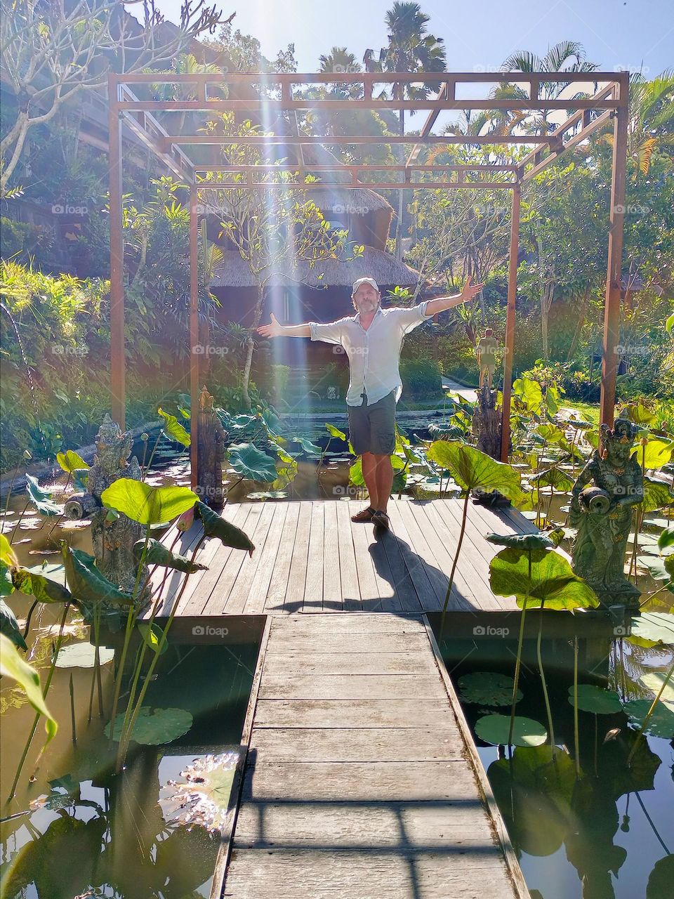 man in the middle of lotus flower pond