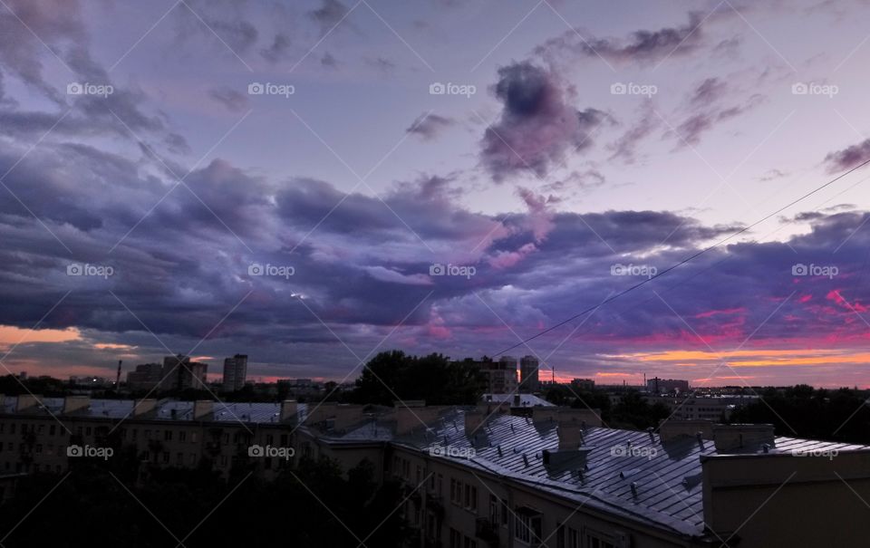 Clouds in the bright pink sunset light.