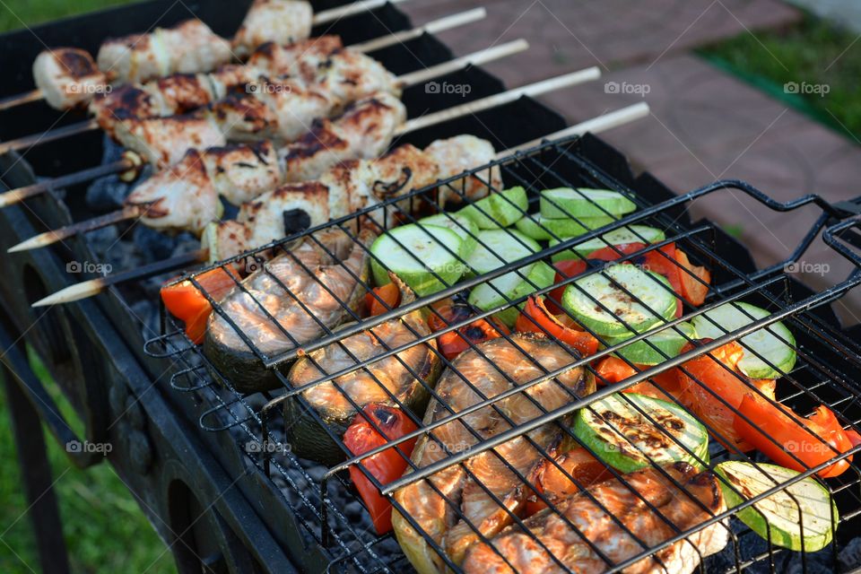 High angle view of preparing foods on barbecue