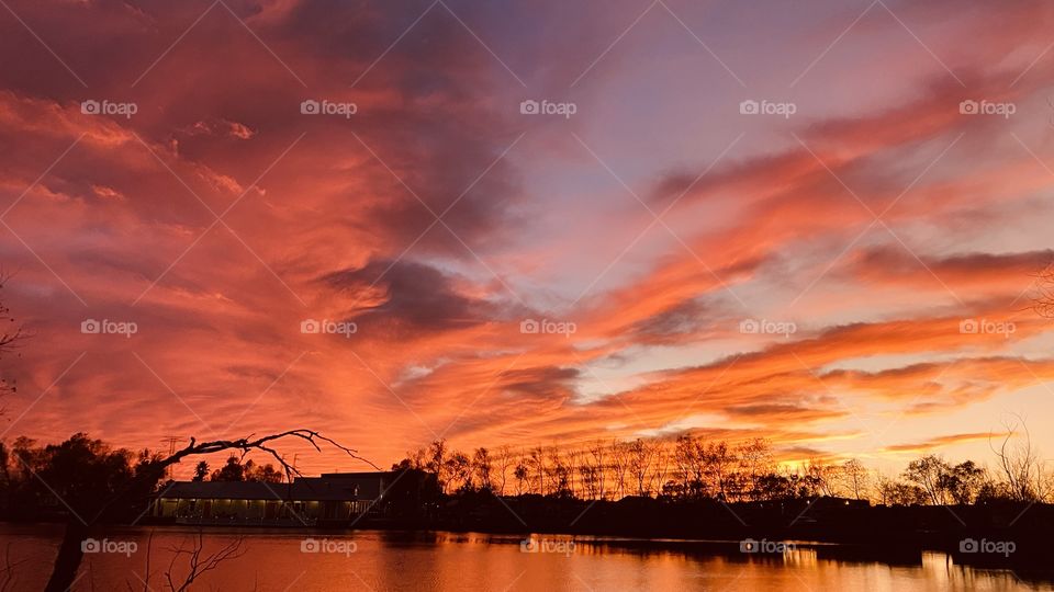 Due to a Cold Airmass Front and the clouds parted late at sunset. As the sun sets deeper into the Horizon Colors get deep and more colors are spread across the sky. 