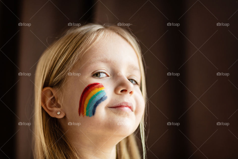 Happy kid with rainbow on face