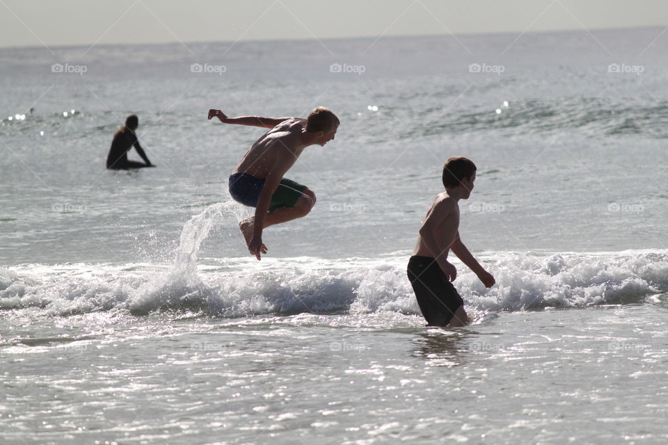 Free to be at the beach.  Enjoying life to its fullest jumping in the waves  