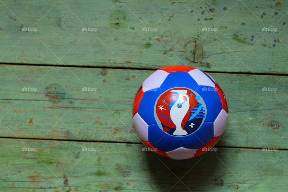 miniature soccer ball from euro 2016 on a wooden table