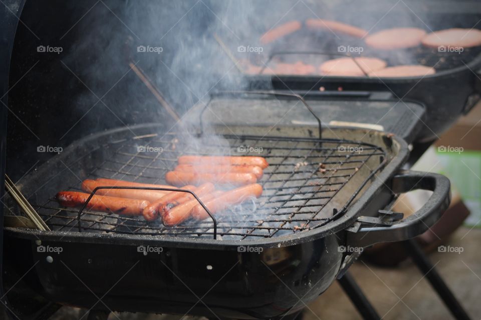 grilling and chilling at home cooking hot dogs 