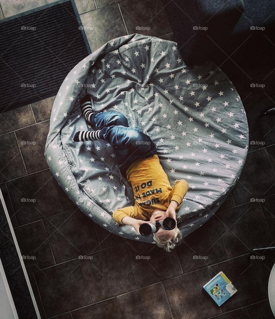 Child looking at the stars with binoculars