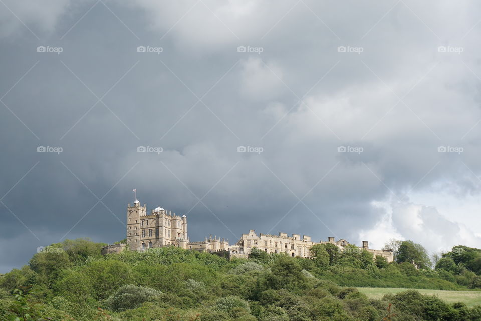 Castle with a backdrop of dark rain clouds ...