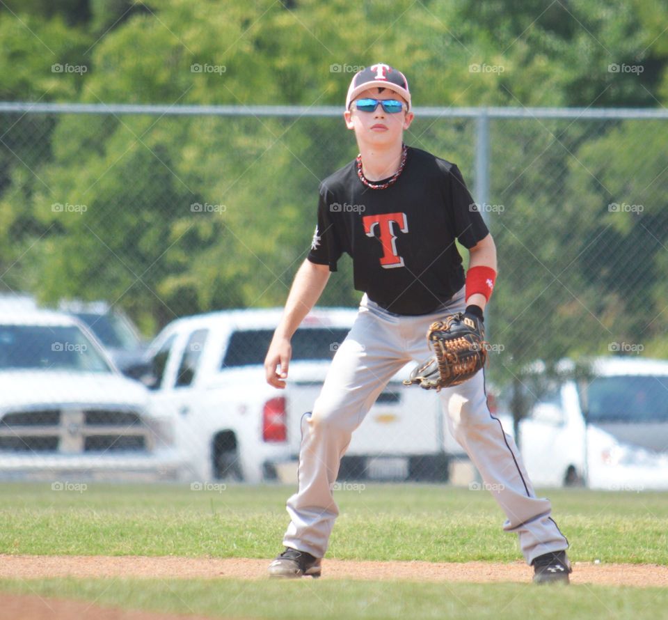 Portrait of teenager baseball player in field