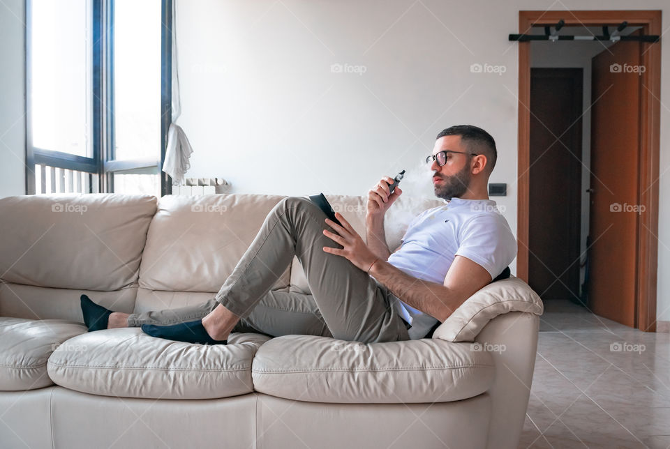 Man smoking while relaxed at home