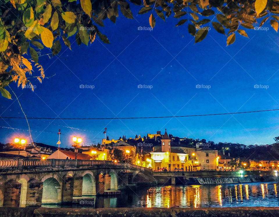 A nighttime view across the Rio Nabão, to the older part of the town and Convent of Christ - Tomar - Central Portugal - July 2019