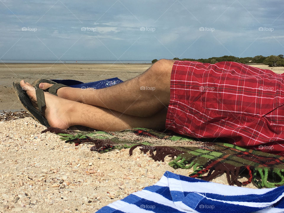 Man in shorts and sandals relaxing on south Australian beach