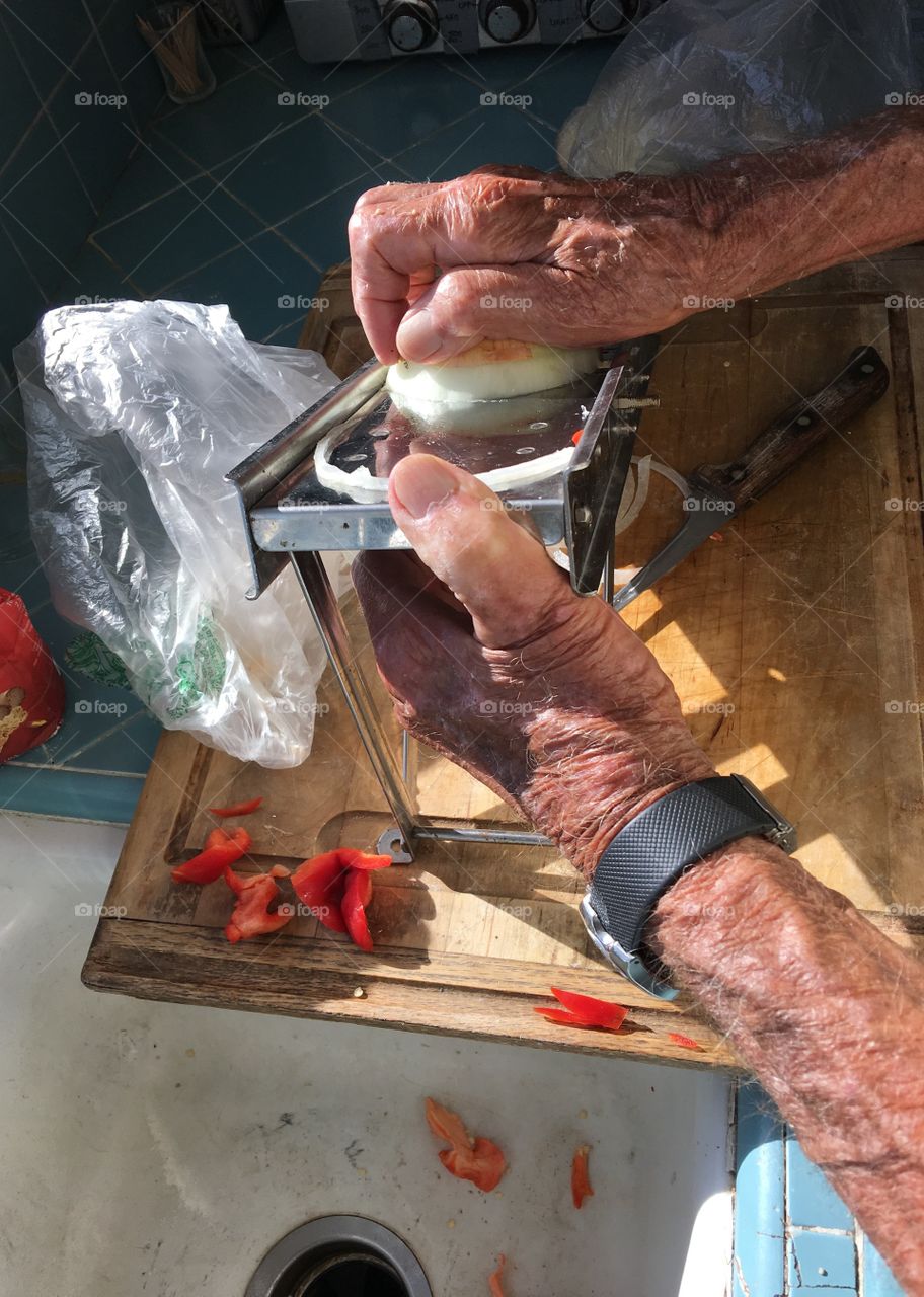 Slicing onions on mandolin 