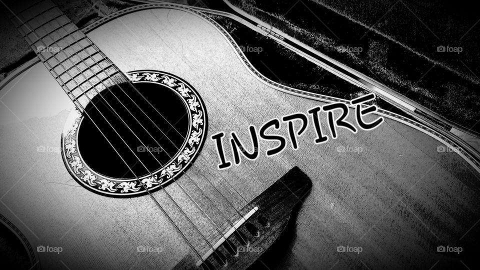 Black & White, Vignette of a guitar in a case with the word "inspire"  on it.
