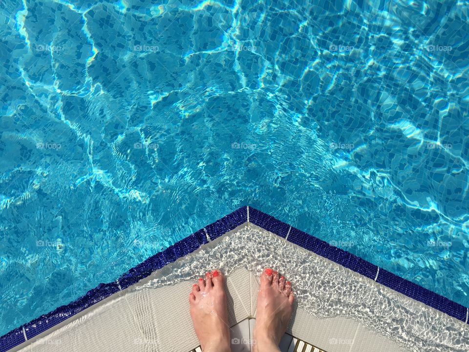 That moment of anticipation, about to escape the searing heat on holiday and dive into a refreshing pool. 