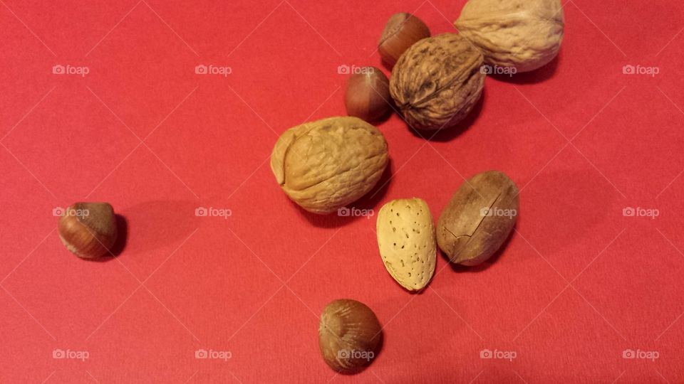 mixed nuts on red background