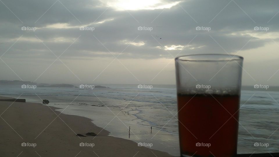 from a window I saw two young boys enjoying themselves near the sea.