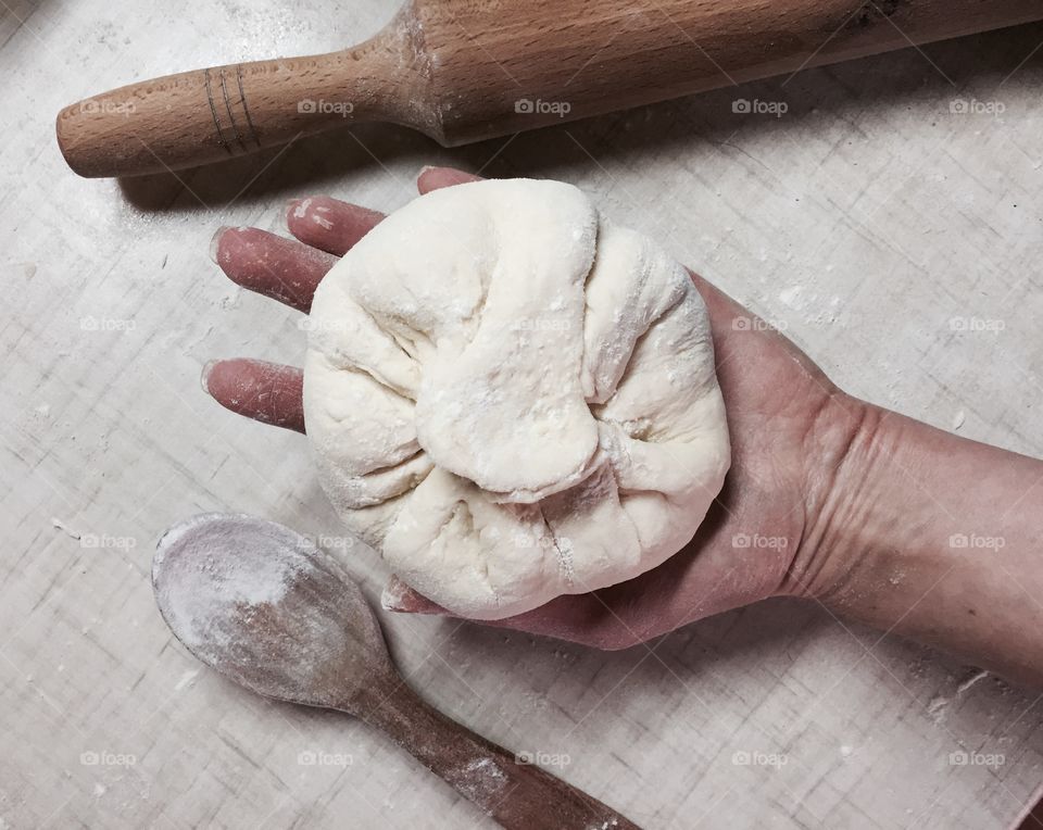 Person hand holding dough