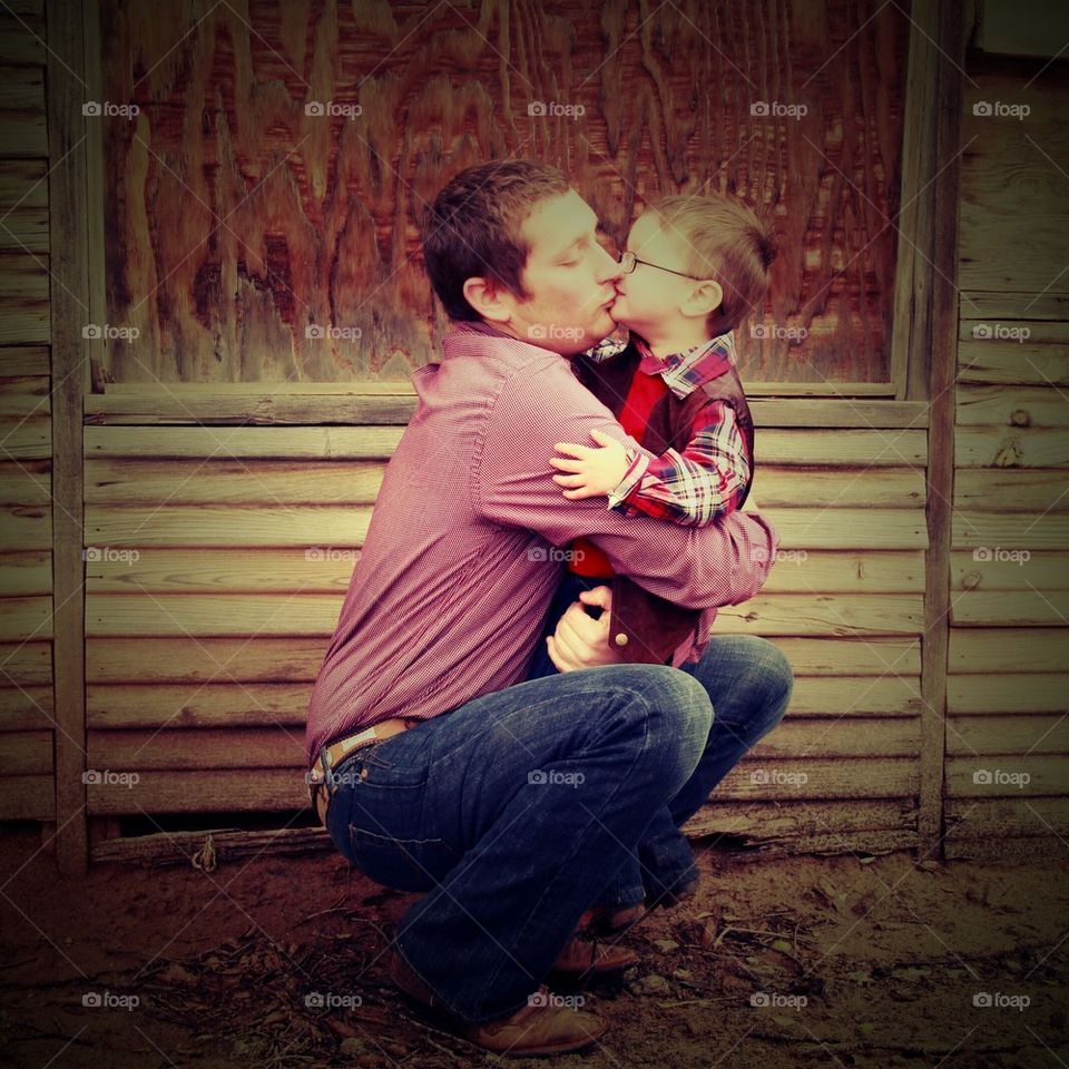 father embracing son